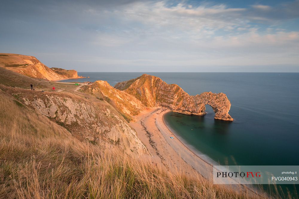 Sunset at Durdle Door, a natural limestone arch on the Jurassic Coast near Lulworth in Dorset, England, UK