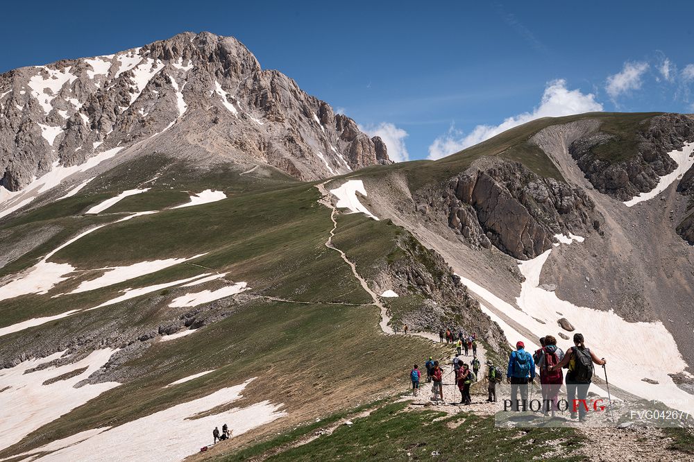 A group of hikers proceed towards the summit of the Gran Sasso, Gran Sasso national park, Abruzzo, Italy, Europe
