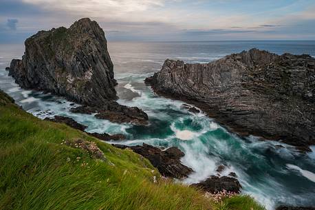 Malin head and its oblique rocks raising from the water, making their stand at the ocean's strength