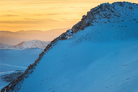the Mount Bolza's ridge, in Campo Imperatore, during a beautiful coloured sunset 