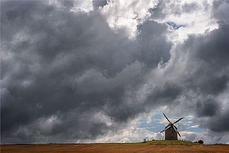 Near the famous Mont Saint Michel you can see picturesque windmills facing the storm