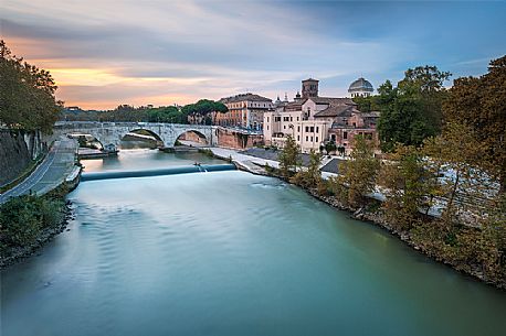 Beautiful and sweet sunset near the tiber Island. The Tiber Island is the only island in the Tiber river which runs through Rome and and has been connected with bridges to both sides of the river since antiquity