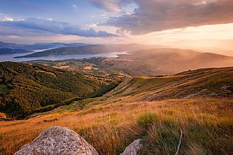 Lake Campotosto at sunset, seen from the Laga mountains, Gran Sasso and Monti della Laga national park, Abruzzo Lake Campotosto at sunset, seen from the Laga mountains, Gran Sasso and Monti della Laga national park, Abruzzo