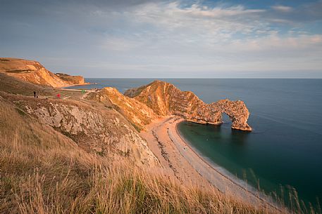 Sunset at Durdle Door, a natural limestone arch on the Jurassic Coast near Lulworth in Dorset, England, UK