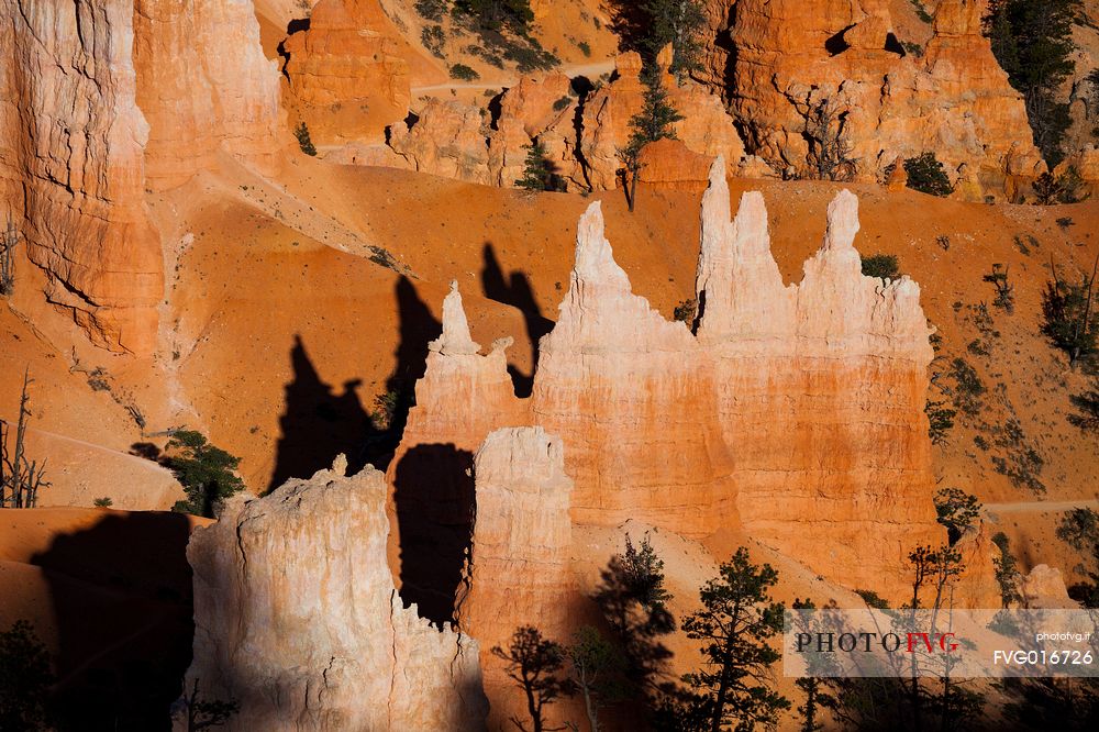 Rocks sculpted by wind and rain in Bryce Canyon , called hoodoos , are believed by the native, to be the ancient petrified inhabitants of this country.