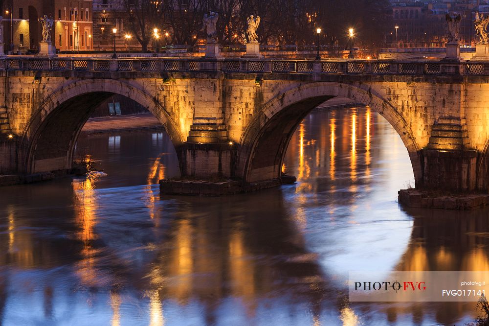 The bridge Sant'Angelo illuminated with reflections on the Tevere's water