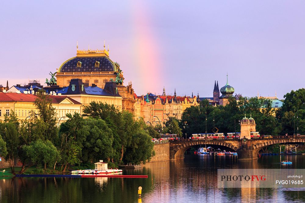 Prague, view across Vltava River and Charles Bridge at sunset with rainbow

