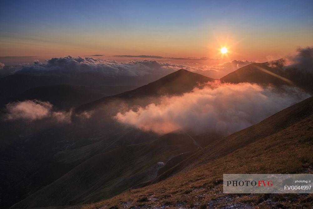Sunset from the top of Pizzo Tre Vescovi peak, view of Fargno hut and Ussita valley, Sibillini national park, Marche, Italy, Europe