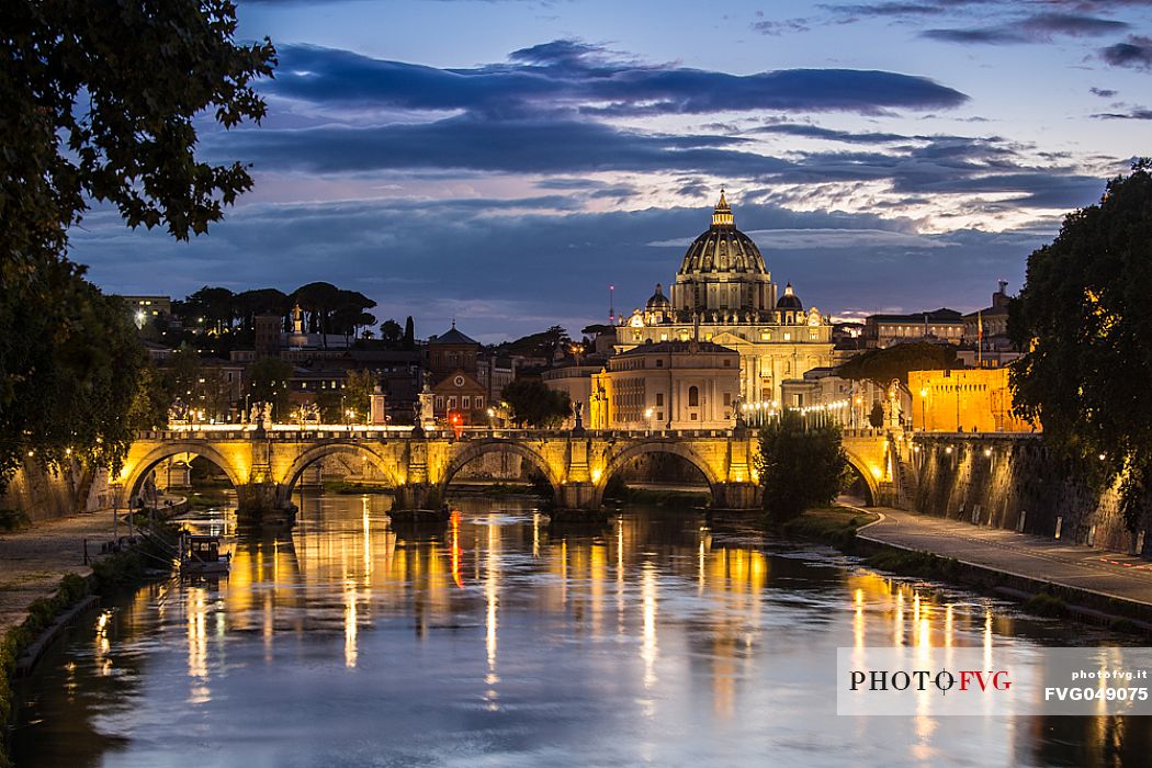Rome: St. Peter's Basilica at the blue hour with the reflection of the lights on the water of the Tiber