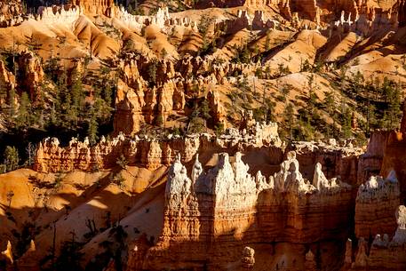 Rocks sculpted by wind and rain in Bryce Canyon , called hoodoos , are believed by the native, to be the ancient petrified inhabitants of this country.