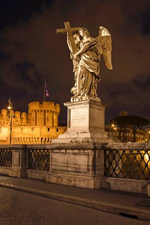 Nighttime image of one of the statues along the bridge Sant'Angelo