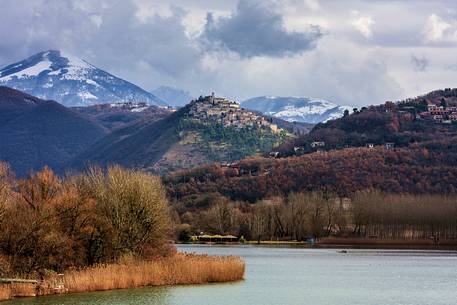 The ancient medieval village of Labro, in  Rieti's province, Lazio. On the background  mountains, covered by snow. Piediluco's lake waters in foreground.