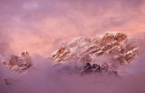 Cortina D'Ampezzo: Cristallo mount and the clouds that envelope it become flushed of rose to the sunset
