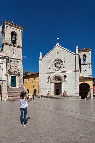 Tourist take a picture of he Basilica of San Benedetto and the Town Hall of Norcia a few months before the earthquake. Umbria, Italy, Europe.