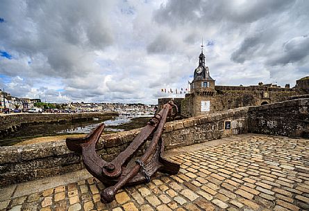 Clock Tower and Anchor on the Bridge leading to the Old Town, Ville Close, in Concarneauan ancient fortified town on the coast of French Cornwall, Brittany, France, Europe                                                         