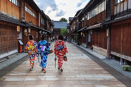 Three girls in kimono in the Higashi Chaya, Geisha district in Kanazawa, where in ancient times the guests of the exclusive clubs were entertained by geishas with songs and dances, Japan