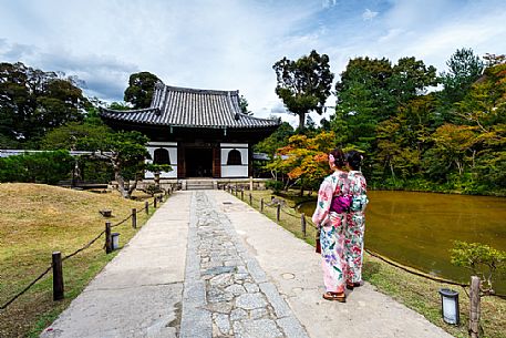 Two japanese girls in kimono looking the ancient temple of Kodai - ji famous for the Zen gardens, Kyoto, Japan