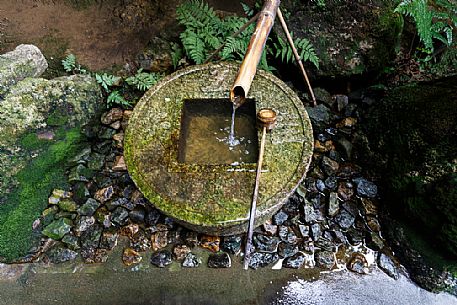Stone water basin  in Ryoan-ji temple, famous for the zen karesansui garden, stone garden, Kyoto, Japan