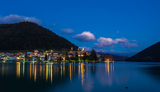 The lake and the village of Piediluco by night with the lights reflected on the water, umbria, Italy, Europe