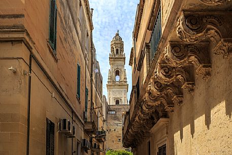 The bell tower of the cathedral Santa Maria Assunta seen from a narrow street in the center, Lecce, Salento, Apulia, Italy, Europe