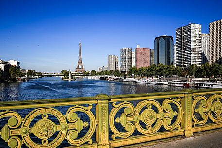 The Seine and the Eiffel tower seen from the pont Mirabeau of which we see the characteristic iron railing of 1896, Paris, France, Europe