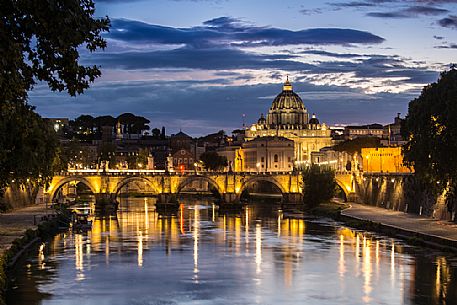 Rome: St. Peter's Basilica at the blue hour with the reflection of the lights on the water of the Tiber