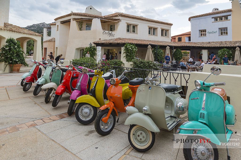 This picture resembles some of the most italian icons Vesp, the notorious scooter by Piaggio. Porto Cervo, one of the most famous and classy  destinations in Sardinia. Italy