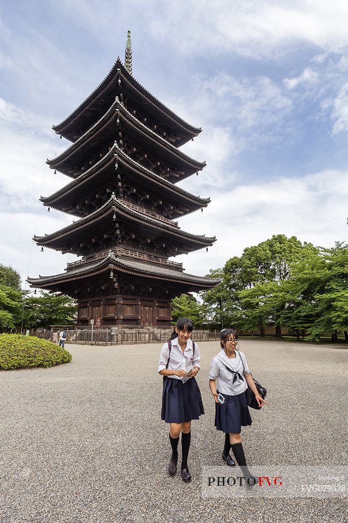 Students in the famous  To-ji temple gardens, in Minami-ku. The fives story pagoda,  54.8 meters high, is  the tallest wooden tower in Japan and  a Unesco World Heritage site, Kyoto, Japan