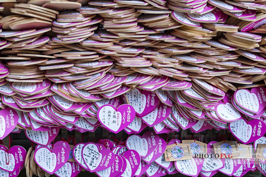 Wooden heart shaped pink Ema boards, Kasuga - Taisha Shrine common to Japan, in which shinto and buddhist write prayers or wishes, Nara, Japan