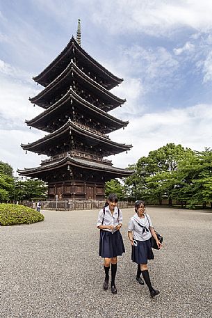 Students in the famous  To-ji temple gardens, in Minami-ku. The fives story pagoda,  54.8 meters high, is  the tallest wooden tower in Japan and  a Unesco World Heritage site, Kyoto, Japan