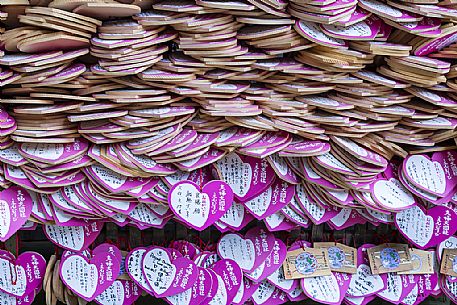 Wooden heart shaped pink Ema boards, Kasuga - Taisha Shrine common to Japan, in which shinto and buddhist write prayers or wishes, Nara, Japan