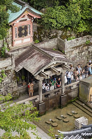 The Otowa Waterfall in the main hall of Kiyomizu-dera temple. Visitors use cups attached to long poles to drink from them. It's a Unesco World Heritage Site, Kyoto, Japan