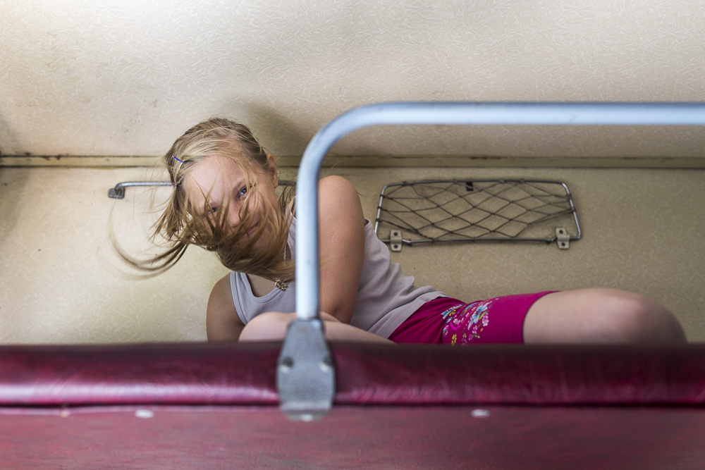 A russian child playing in the Transiberian train from Moscow to Novosibirsk, Russia