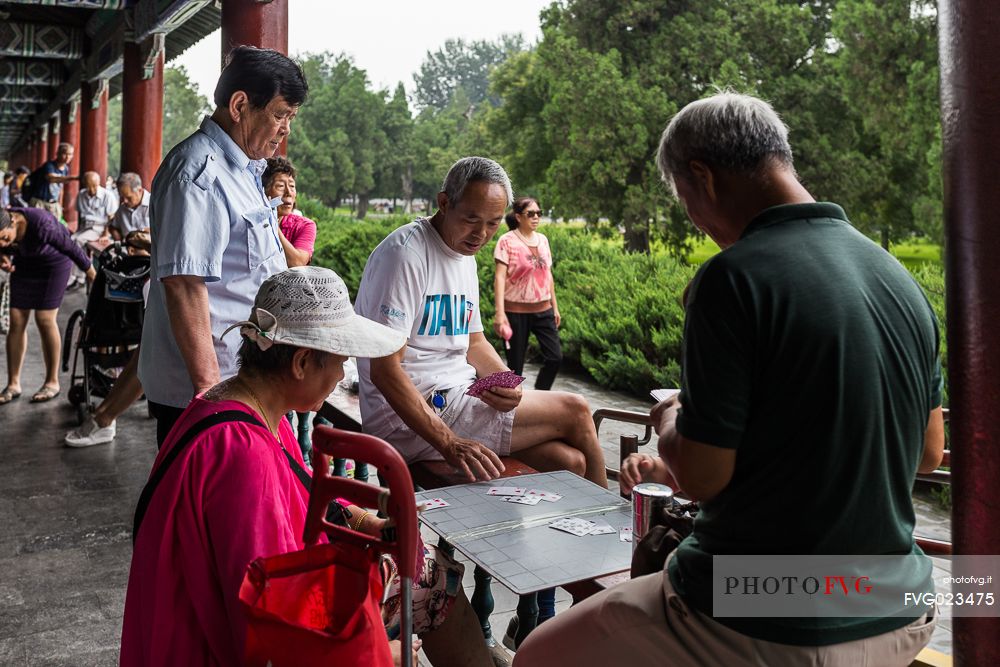 Elderly people playing table game inside the Summer Palace in Beijing