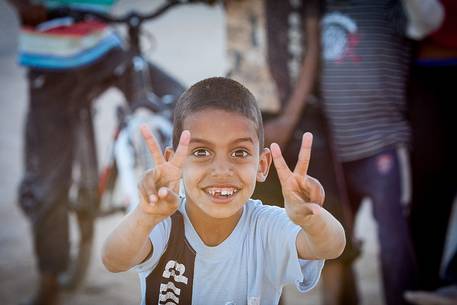 A child smiling at the camera in the refugee camp of Smara