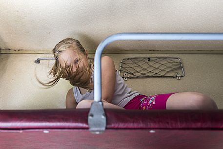 A russian child playing in the Transiberian train from Moscow to Novosibirsk, Russia