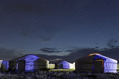 Traditional tents under a starry sky in Mongolian steppe, Mongolia