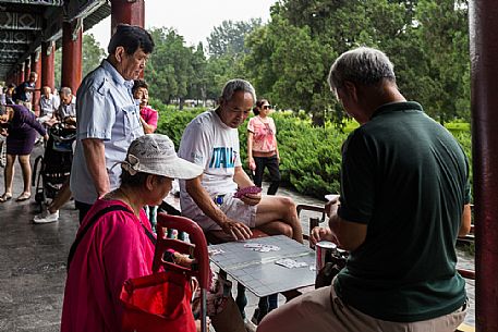 Elderly people playing table game inside the Summer Palace in Beijing