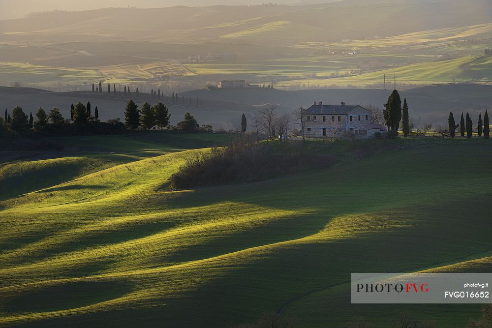 The early morning light caresses the rolling Tuscan hills