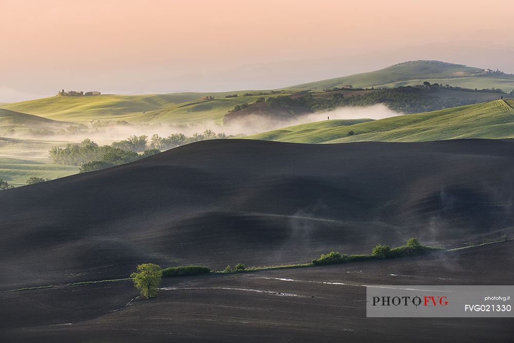 The sun dries the plowed land in Orcia valley, Tuscany, Italy