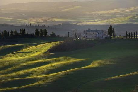 The early morning light caresses the rolling Tuscan hills