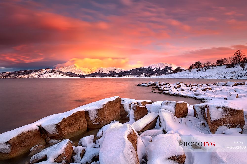 A blizzard reveals the tops of the Gran Sasso mountain range. During the winter the Campotosto lake can be one of the most evocative scenery of the whole Gran Sasso and monti della Laga National Park, Abruzzo, Italy