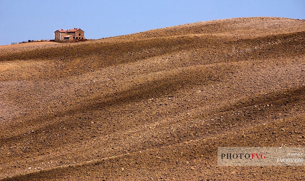 Farm adn plowed fields in the hills of the Val d'Orcia, Tuscany, Italy, Europe