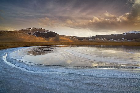 Melting ice in a little pond of Pian Grande di Castelluccio di Norcia, Sibillini National Park, Umbria, Italy, Europe