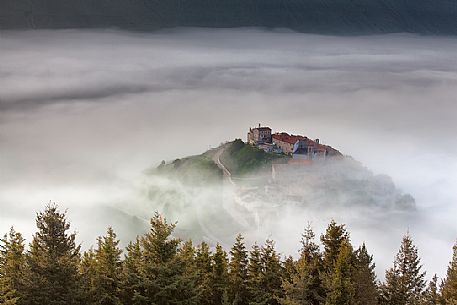 Castelluccio di Norcia village and the Pian Grande in the fog, Sibillini National park, Umbria, Italy, Europe