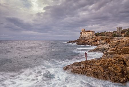 Boccale castle and fisherman in the storm, Livorno, Tuscany, Italy