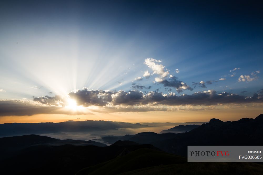 Sun rays through the cluods in the Apuane Alps, Penna di Sumbra mount, Tuscany, Italy, Europe