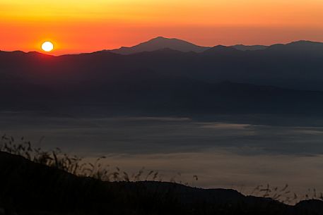 Red sunrise on Apuane alps, Penna di Sumbra mount, Tuscany, Italy, Europe