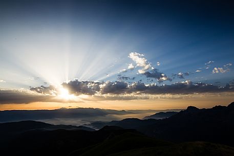 Sun rays through the cluods in the Apuane Alps, Penna di Sumbra mount, Tuscany, Italy, Europe