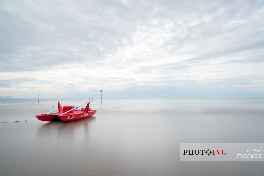 Red rescue boat moored in the Adriatic coast, Friuli Venezia Giulia, Italy, Europe